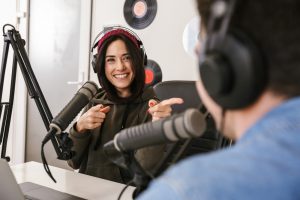 Man,And,Woman,In,White,Shirts,Podcasters,Interview,Each,Other